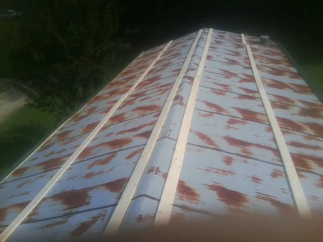 Rusted metal roof panels with new wood purlins before replacement — Storm Damage Roof Repair in Bonita by Roofing Brothers